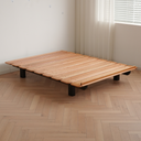 Born in Colour wooden slat bedframe with black legs on parquet flooring by a window