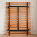 Born in Colour wooden slat bedframe with black metal support frame against white wall