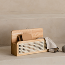 Wooden basket with wicker interior on a beige surface
