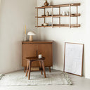 Born in Colour wooden sideboard in minimalist room with decorative shelf and stool