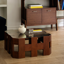 Modern wooden sofa table with glass top and open geometric design in living room setting