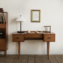 Born in Colour wooden Study Desk with two drawers, a table lamp, and decorative items in a minimalist room